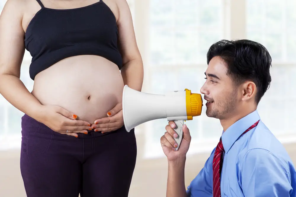 men talking to pregnant